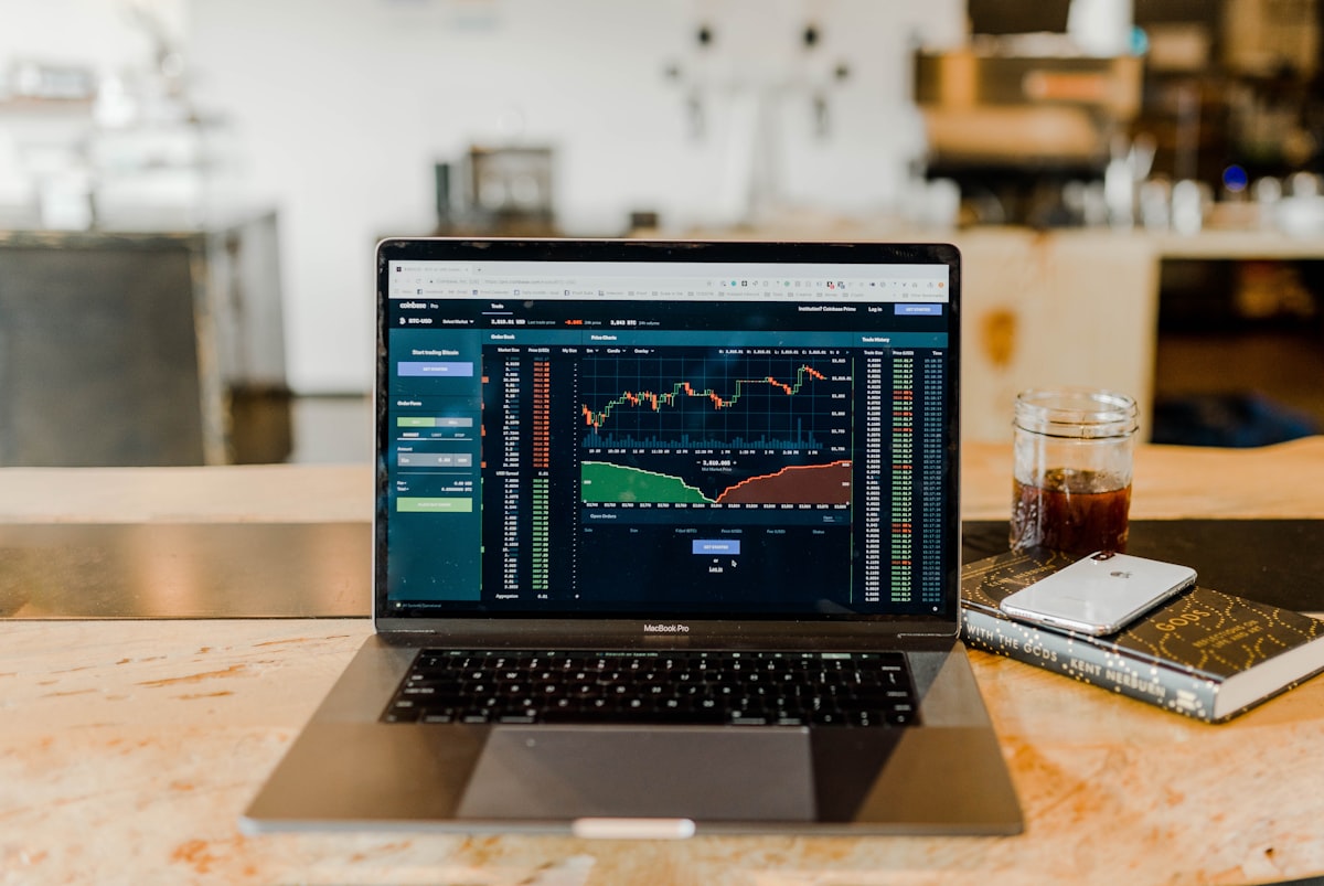 Laptop displaying trading charts